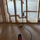 Laundry box rough-in connected to a test gauge assembly and Milwaukee inflator during a DWV pressure test.