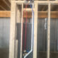 Shower rough-in framing showing red and blue PEX lines connected to a brass mixing valve with PVC vent.