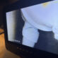 Sewer inspection camera screen revealing a cracked PVC sanitary tee hidden inside a wall cavity.