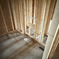 2CE9DC82 2E17 4BAD AD3F EC10CE6E048D d4569e54 9596 4118 b2e9 466c761b66c7 Bathroom rough-in featuring toilet flange on subfloor and in-wall drain line for bathroom sink.