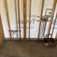 ReactNativeBlobUtilTmp 8whyzkzdxufzq44eltdjkm Laundry room rough-in showing in-wall outlet box, P-trap, PVC vent line, and PEX supply lines.