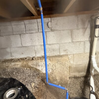 Liberty Pumps SumpJet water powered backup pump installed in Lexington KY 40503 crawl space. Clean blue PEX water line routed to backup sump pump in crawl space.