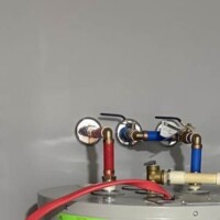 ReactNativeBlobUtilTmp ocbdxrdsqjdry9j267zqei Electric water heater installation highlighting 1/2-inch ball valves, red and blue PEX piping, and a dedicated electrical disconnect.
