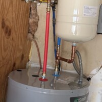 ReactNativeBlobUtilTmp s0s4vcx7s8n0i908wkdy AO Smith 50-gallon water heater featuring a thermal expansion tank, copper fittings, and PEX supply lines