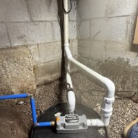 Liberty Pumps SumpJet water powered backup pump installed in Lexington KY 40503 crawl space. Clean blue PEX water line routed to backup sump pump in crawl space.