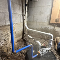 Liberty Pumps SumpJet water powered backup pump installed in Lexington KY 40503 crawl space. Clean blue PEX water line routed to backup sump pump in crawl space.