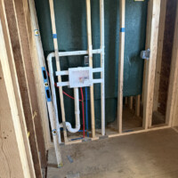 ReactNativeBlobUtilTmp c7j35zox91cjkg9cdhxldq Laundry box installation framed in wall studs with PEX lines and P-trap rough-in for washing machine hookup.