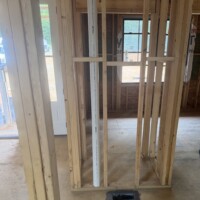 ReactNativeBlobUtilTmp negnbs2jejmjlbkdikfs Vertical 3-inch PVC vent pipe rough-in framed inside wall studs near an HVAC floor register cutout in Bardstown, KY.