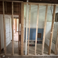 ReactNativeBlobUtilTmp tkdgwg12o6923st8e9s0ab Open wall studs showing vertical PVC vent stack installation in an ongoing whole-home gut renovation.
