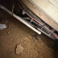 ReactNativeBlobUtilTmp x842ms68w19kpmgokp9j8g Detailed view of properly sloped Cresline 1.5-inch PVC waste branches secured under floor joists.