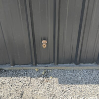 ReactNativeBlobUtilTmp xvz10g3hgvij0d7jixerc8 Frost-free outdoor hose bibb installed flush against dark corrugated metal siding.
