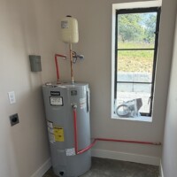ReactNativeBlobUtilTmp y29377u7d9imzzc9j9t2f Reliance electric water heater installation with top-mounted expansion tank and thermal expansion loop piping.