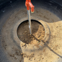 ReactNativeBlobUtilTmp 90qg07abyipvqk8kk17nda Excavated trench showing underground water supply pipe connecting to frost-proof yard hydrant base.