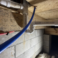 ReactNativeBlobUtilTmp chec6f2d4p782p54e1apaa Under-floor crawlspace layout displaying gas piping run and color-coded red and blue PEX water lines strapped to joists.
