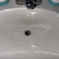 ReactNativeBlobUtilTmp ptz3ii7ujkl31vcprw3ib Close-up of bathroom sink basin with open drain hole during drain body swap.