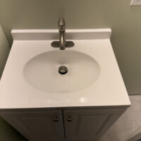ReactNativeBlobUtilTmp j2do5ons4n8gar6u6yqifd Top-down view of a modern white vanity sink with brushed nickel faucet hardware.